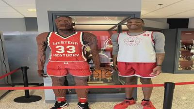 Jamarion Sharp stands next to Lego sculpture in his likeness