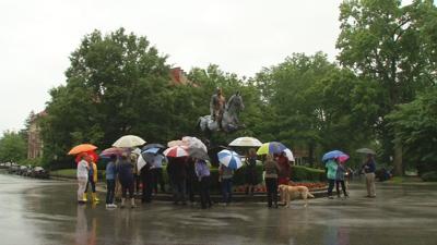 Members of Friends of Louisville Public Art gather at Castleman statue