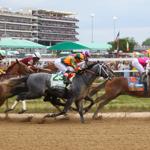 Horses with Churchill Downs in backdrop.JPG