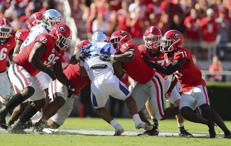 Kentucky running back Chris Rodriguez tackles by Georgia defenders.jpeg