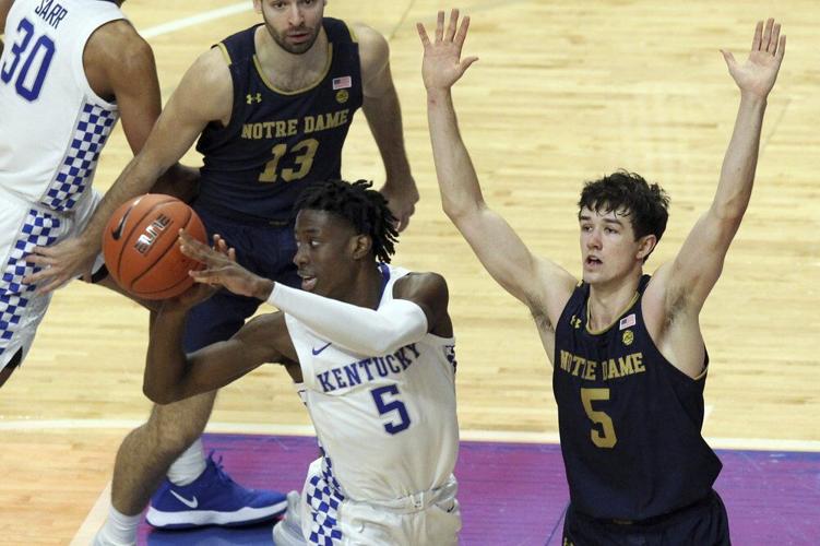 Kentucky's Terrence Clarke, left, passes away from the defense