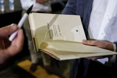 Hillbilly Elegy book being signed by JD Vance 2021