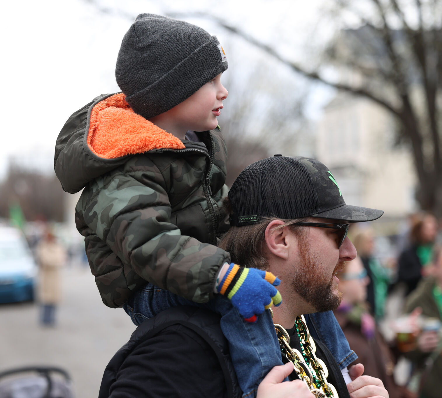 Father carries son on shoulders