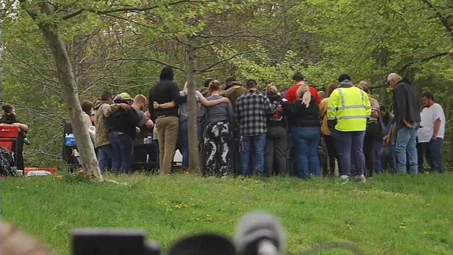 People gather at the Greenwood Boat Dock for a prayer after deadly boat crash