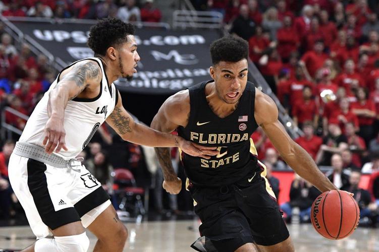 Florida State guard Anthony Polite (2) attempts to get away from the defense of Louisville guard Lamarr Kimble