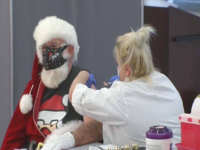 Santa Claus receives a dose of Moderna's COVID-19 vaccine