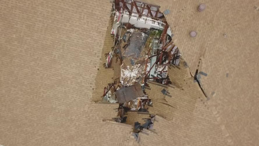 Hole grows in roof of strip mall