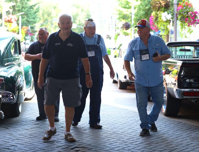 Men walk to view Street Rods.JPG