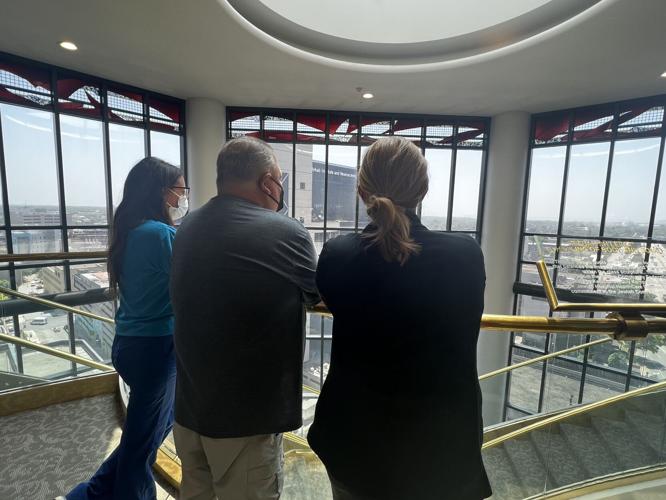 Munday looks out over Louisville alongside two nurses who helped save his life during innovative surgery.