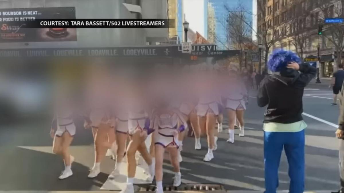 Cheerleaders enter Kentucky International Convention Center during protest