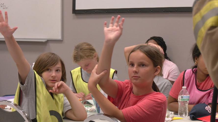 Around two dozen young girls participate in the third annual Lesley Prather Empowerment Camp at the Louisville Fire Training Academy