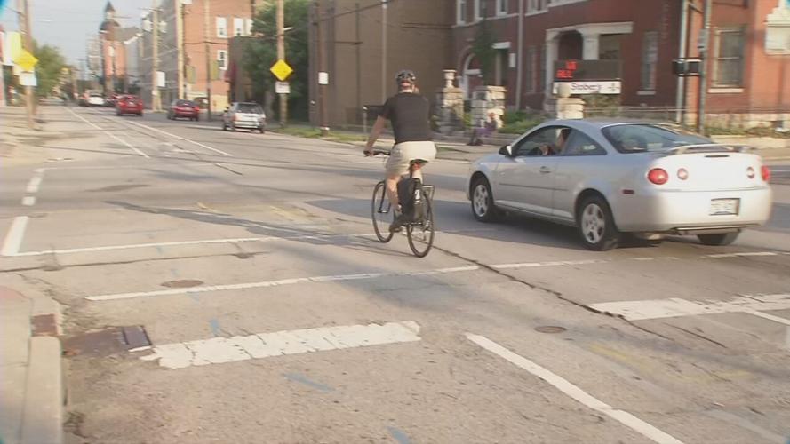 A man travels by bike through Louisville, Ky.