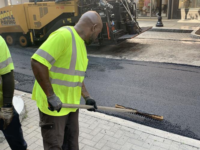 Louisville Metro Public Works crews pave a downtown Louisville road on July 26, 2023