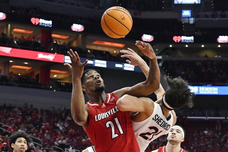 Louisville forward Sydney Curry battles Virginia forward Kadin Shedrick.jpeg