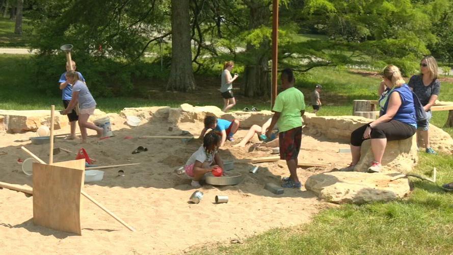 Children play at a playground at Bernheim Forest