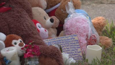 Balloons and teddy bears at vigil.