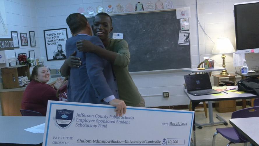 Shalom Ndimubwihisho gets presented with giant check