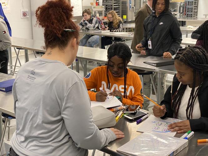 Chef Nikkia Rhodes teaches students during Iroquois High School culinary arts class