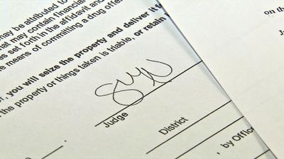 warrants signature credit Zach Crabtree WDRB.jpeg
