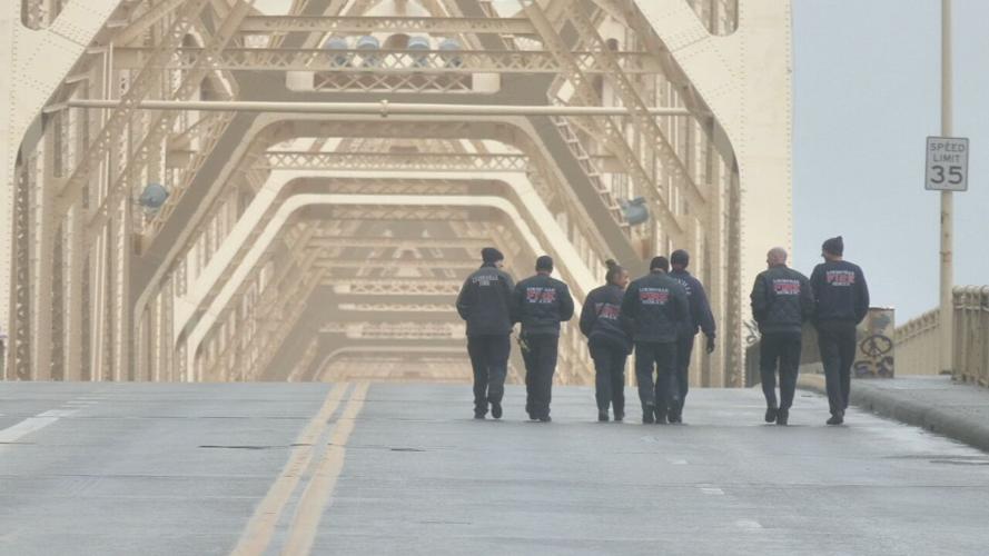 Louisville Firemen walk on 2nd Street Bridge after rescuing semi driver