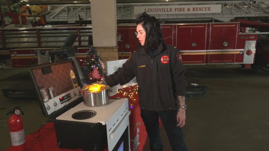 Ashby Green with Louisville Fire's Fire Prevention Bureau demonstrates fire prevention tips on Dec. 20, 2022