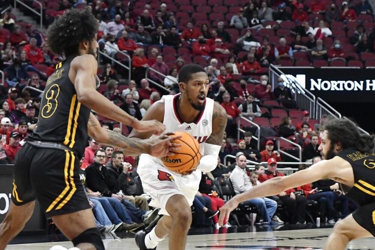 Louisville guard Mason Faulkner fights his way past Southeastern Louisiana.jpeg