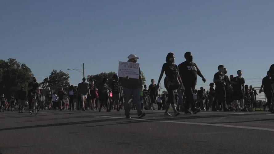 Protesters march around Churchill Downs on Derby day