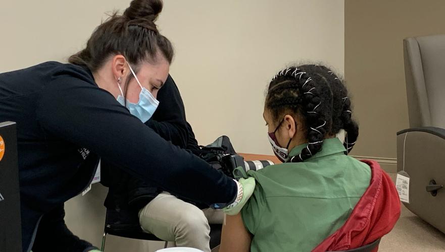 Child receiving COVID-19 vaccination at Norton Healthcare's Breckenridge Lane clinic