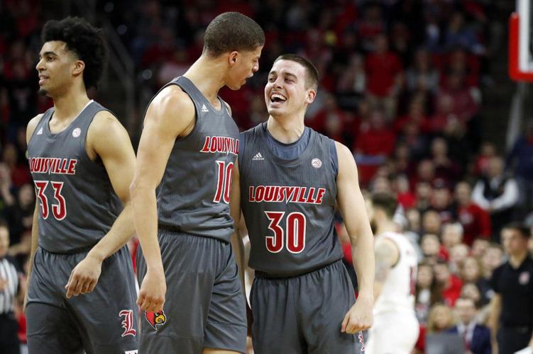Louisville's Ryan McMahon (30) celebrates one of his 3-point shots with teammate Samuell Williamson