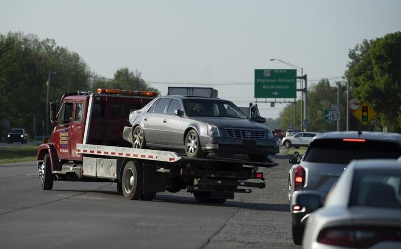 Workers tow Cadillac sedan driven by fugitives Casey White and Vicky White (no relation) in May 2022