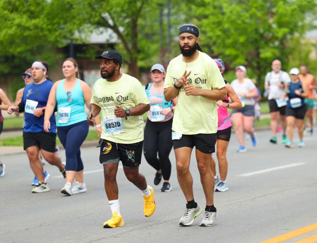 Two men run on Broadway.JPG