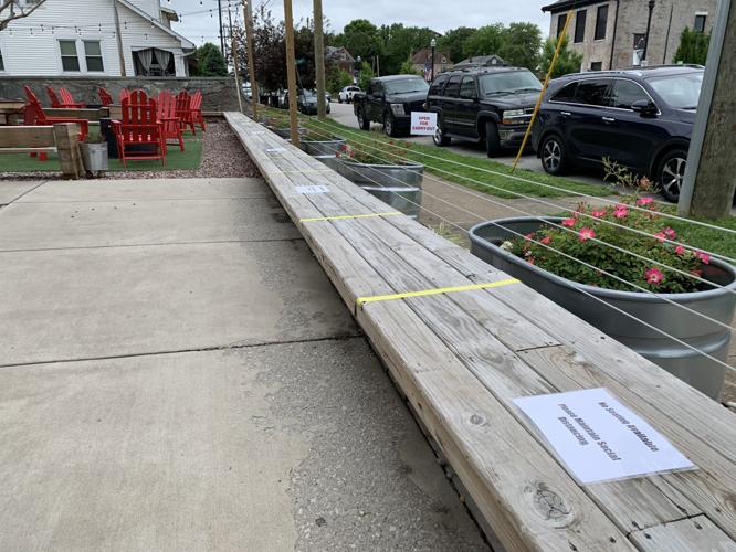 Tape marks the benches at Parlour Pizza for social distancing