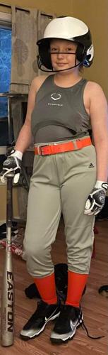 Alaina Kenney poses in softball uniform