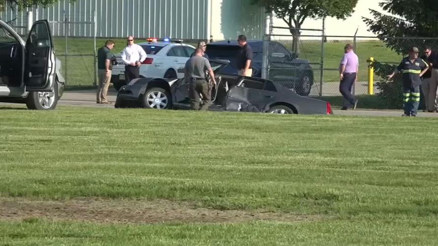 Investigators surround Cadillac sedan driven by fugitives Casey White and Vicky White (no relation) in May 2022