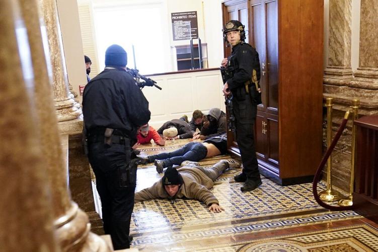 U.S. Capitol Police hold protesters at gun-point near the House Chamber