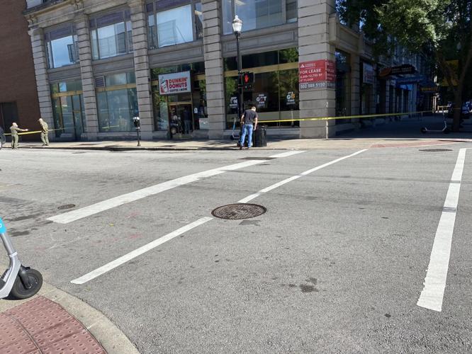ATF agent checks trash can at 4th and Liberty in downtown Louisville