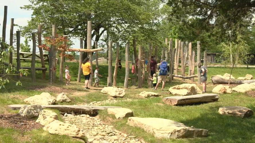 Children play at a playground at Bernheim Forest