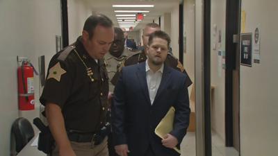 Oberhansley wearing suit in courtroom hall - 8-22-19