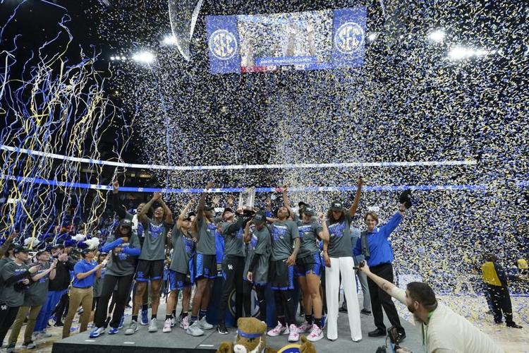 Kentucky players and coaches celebrate after beating South Carolina to win the SEC tournament championship.jpeg