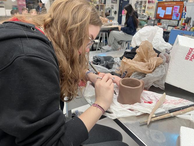 A student at Providence High School in Clarksville paints a bowl for the 2023 Empty Bowl Dinner