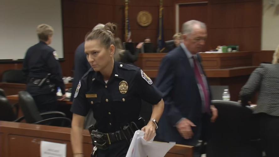 LMPD Officer Hume in court with documents