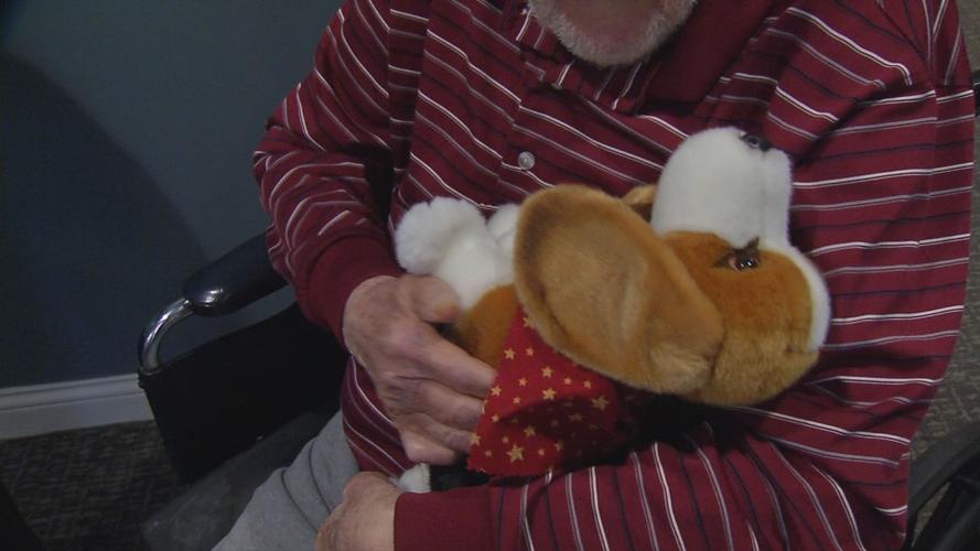 Senior with stuffed puppy brought by Pearl's Memory Babies