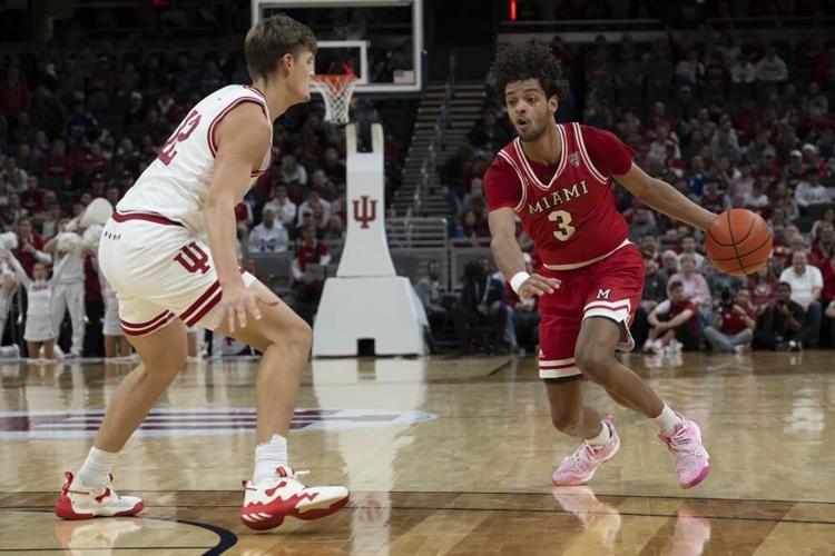 Miami guard Julian Lewis dribbles around Indiana forward Miller Kopp.jpeg