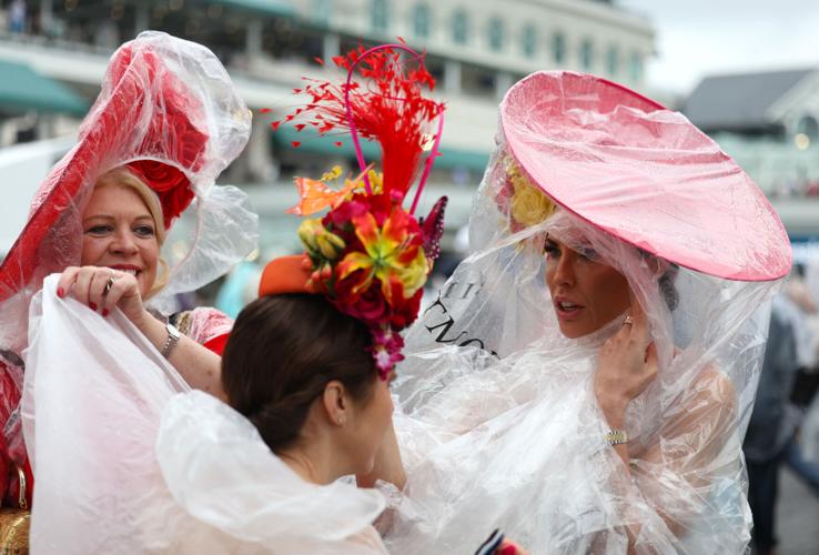 Women adjust ponchos at Churchill Downs.JPG