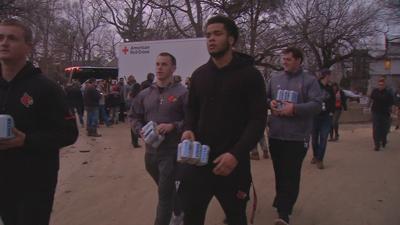 U of L football team helps flood victims clean up Riviera neighborhood