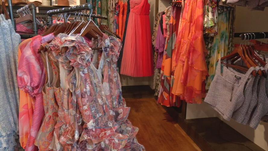 Clothes on racks at Him & Her Boutique