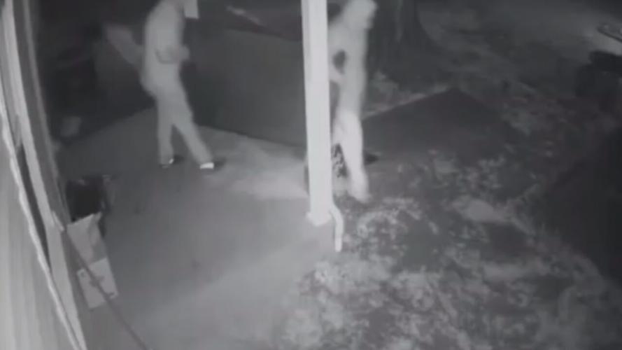 Thieves walk out with television.jpeg