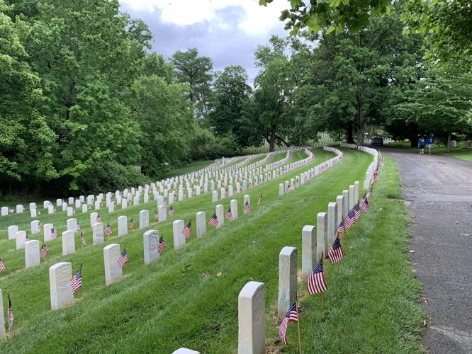 Flags placed on the graves of veterans at Cave Hill Cemetery on Friday, May 27, 2022