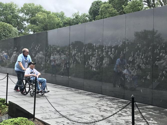 Honor Flight Bluegrass man in wheelchair near Wall