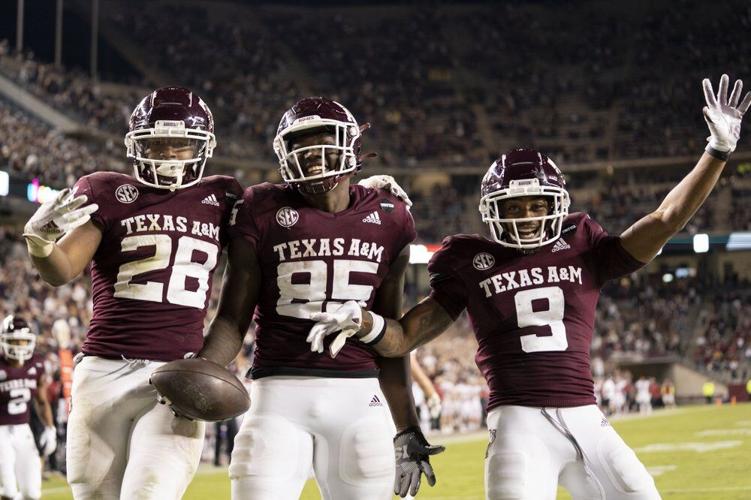 Texas A&M tight end Jalen Wydermyer (85) celebrates with Isaiah Spiller (28) and Hezekiah Jones